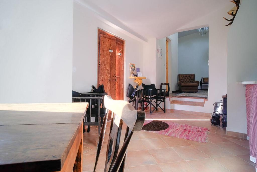 a living room with a table and chairs in a room at Kochab Sintra by LovelyStay in Sintra