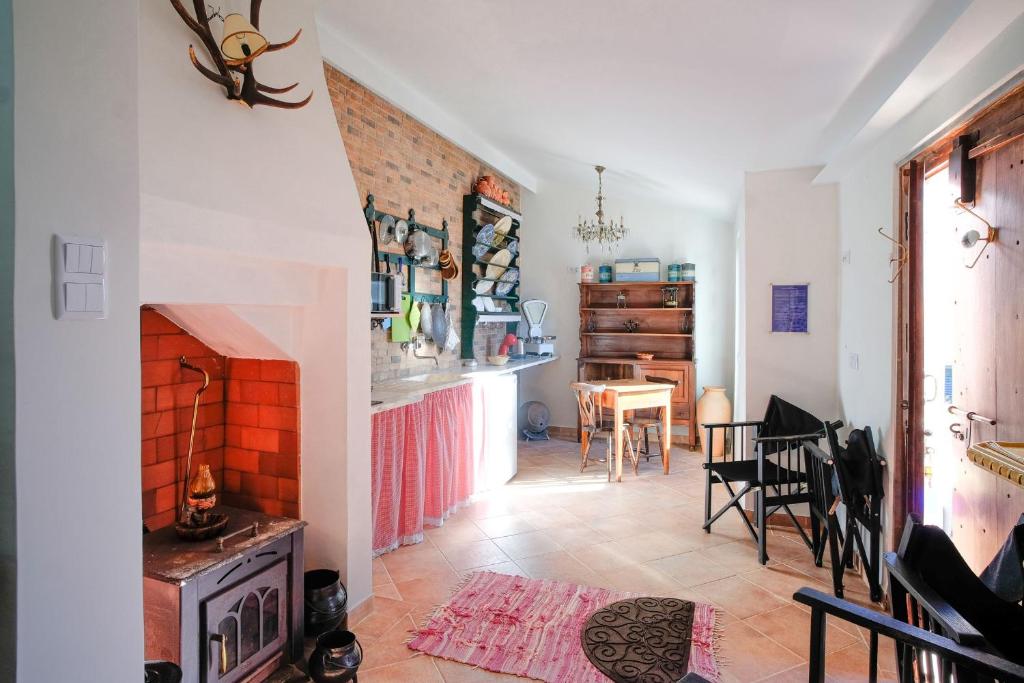 a living room with a fireplace and a table at Kochab Sintra by LovelyStay in Sintra