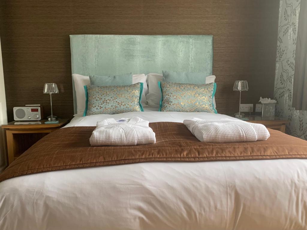 a large white bed with two pillows on it at Ramsey House - Luxury Licensed B&B - Parking and Guest Lounge in St. Davids