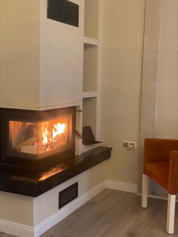 a fireplace in a living room with a fire in it at Grand Alaçatı Butik Hotel in Alaçatı