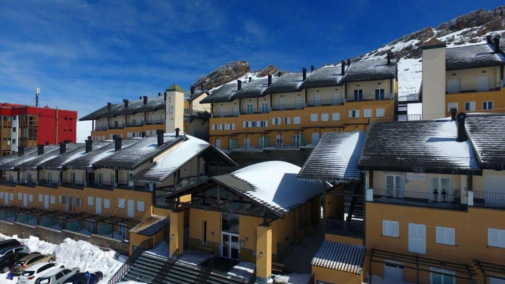 eine Reihe von Gebäuden mit Schnee auf den Dächern in der Unterkunft Vista Nevada Summer in Sierra Nevada