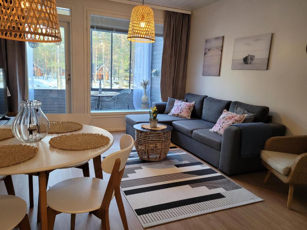 a living room with a couch and a table at Kanervikko in Kalajoki