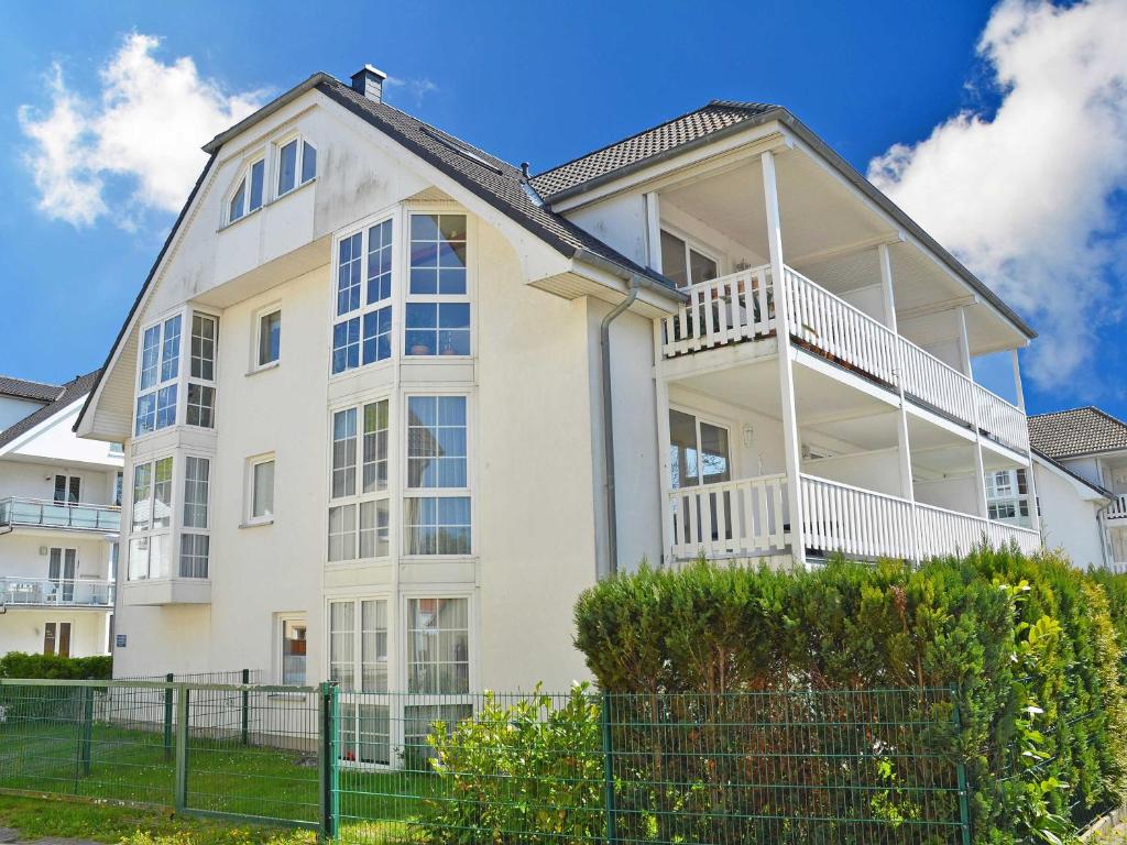 a large white house with a fence in front of it at Ferienwohnungen Schulte in Baabe