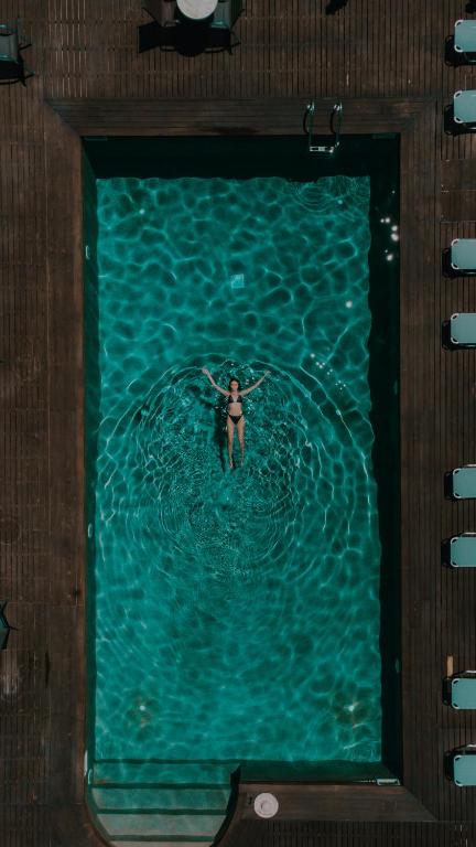 a woman swimming in a pool of water on a boat at Palacio del Sol Luxury Apartments in Nafplio