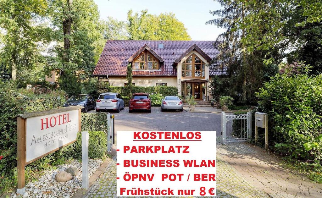 a house with a sign in front of it at Hotel am Katharinenholz in Potsdam