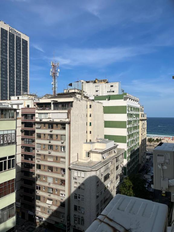 a group of buildings with the ocean in the background at monolocale, a copacabana in Rio de Janeiro