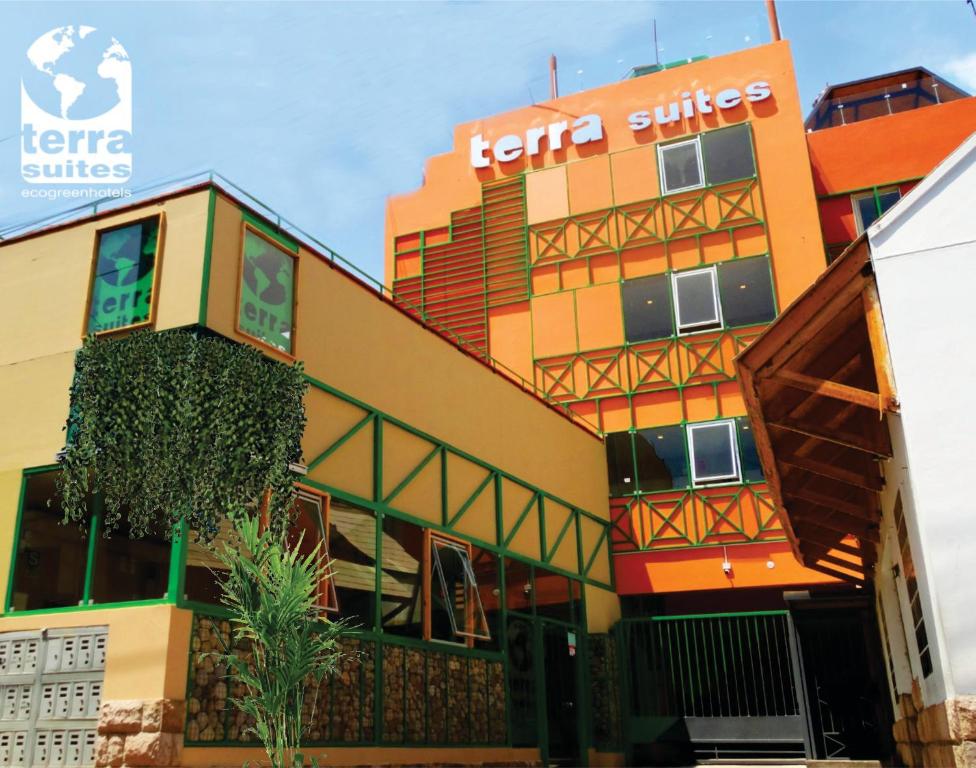 a building with a sign on the side of it at Terra Suites Ecogreen in Tacna