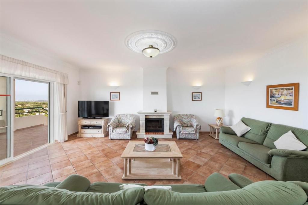 a living room with a couch and a table at Casa Campo in Loulé