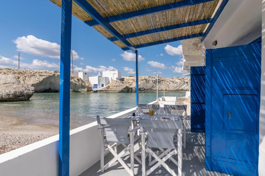 a table and chairs on a boat on the water at Almera Sea View Boat House in Adamas