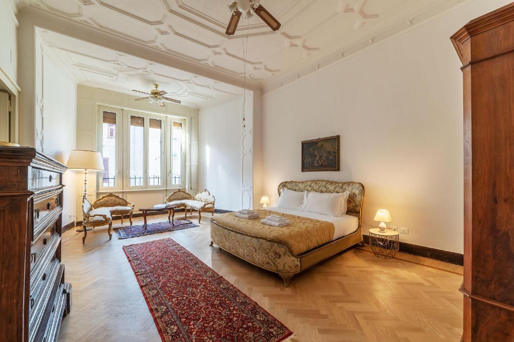 a bedroom with a king sized bed and a living room at CS Vatican Charming Apartment in Rome