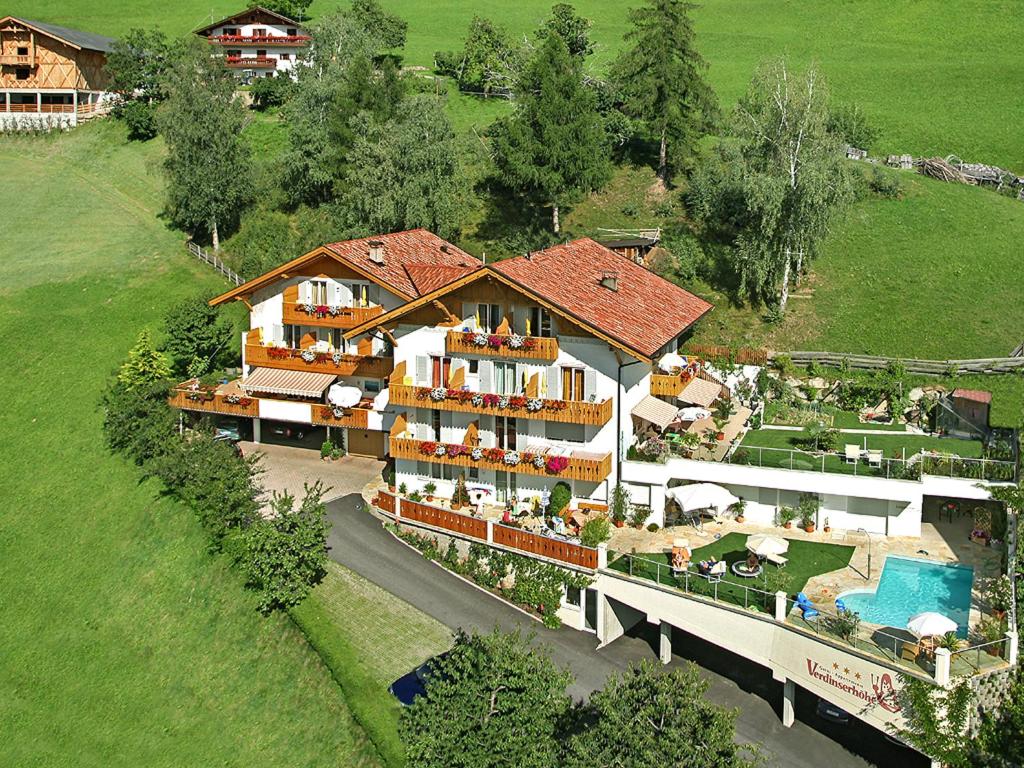 an aerial view of a house with a swimming pool at Pension Verdinserhöhe in Schenna