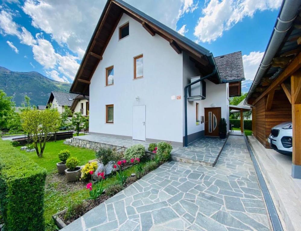a white house with a driveway at APARTMA BRDO BC in Bovec