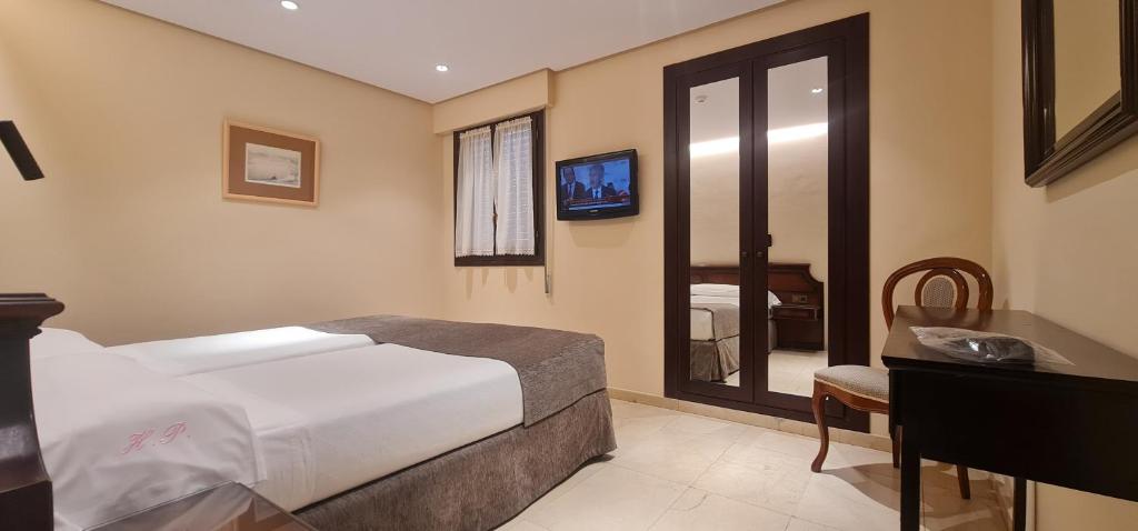 Postel nebo postele na pokoji v ubytování Gran Hotel Paraiso