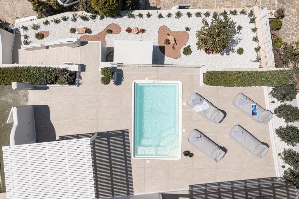 an overhead view of a swimming pool with a building at Diadema Villa in Naxos Chora