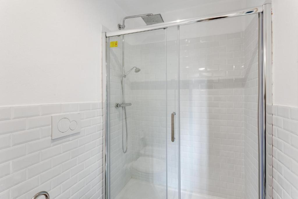 a shower with a glass door in a bathroom at Maison d'Orange - La Pinede in Saint-Tropez