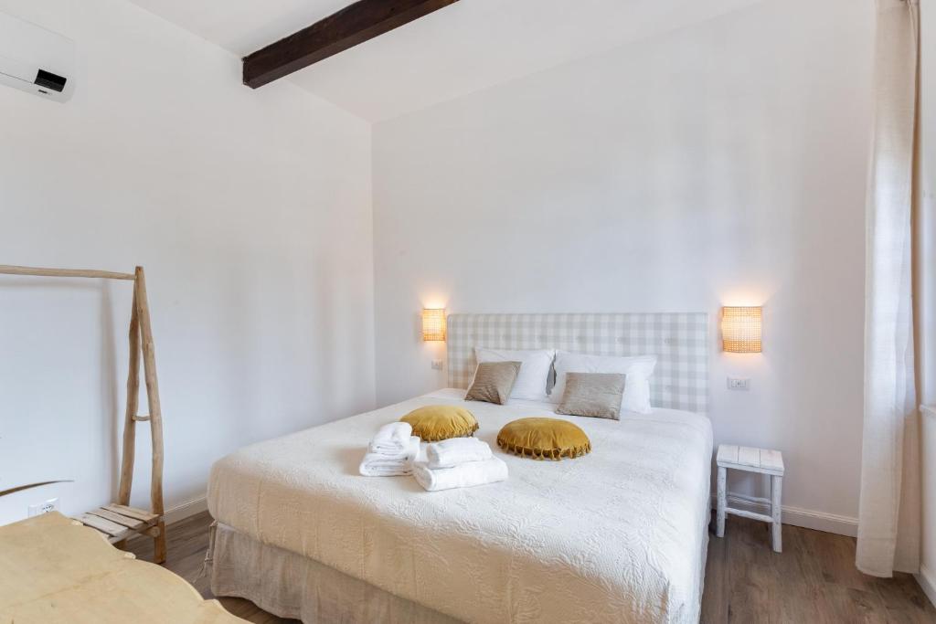 a bedroom with a bed with towels on it at Maison d'Orange - La Pinede in Saint-Tropez
