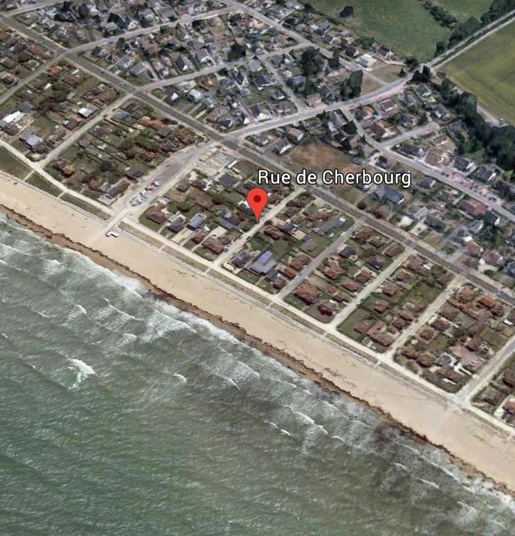 a map of a beach with a red marker at La plage au bout du jardin &#47; Sword Beach cottage in Hermanville-sur-Mer