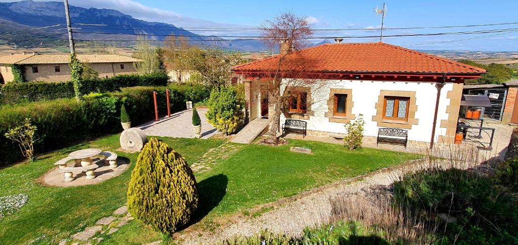 ein kleines Haus in einem Hof mit Rasenfläche in der Unterkunft Legado De Zabala, Casa Rural in Laguardia