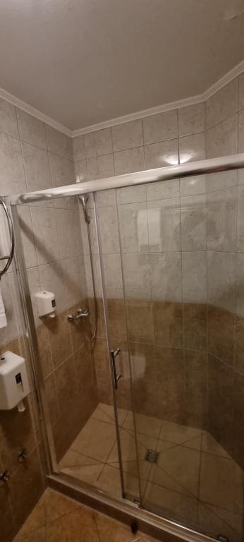 a shower with a glass door in a bathroom at SOBE/ROOMS RIVA in Zadar