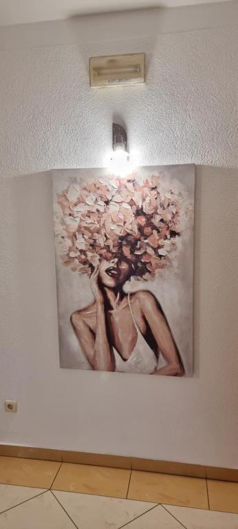 a painting of a woman on a wall at SOBE/ROOMS RIVA in Zadar