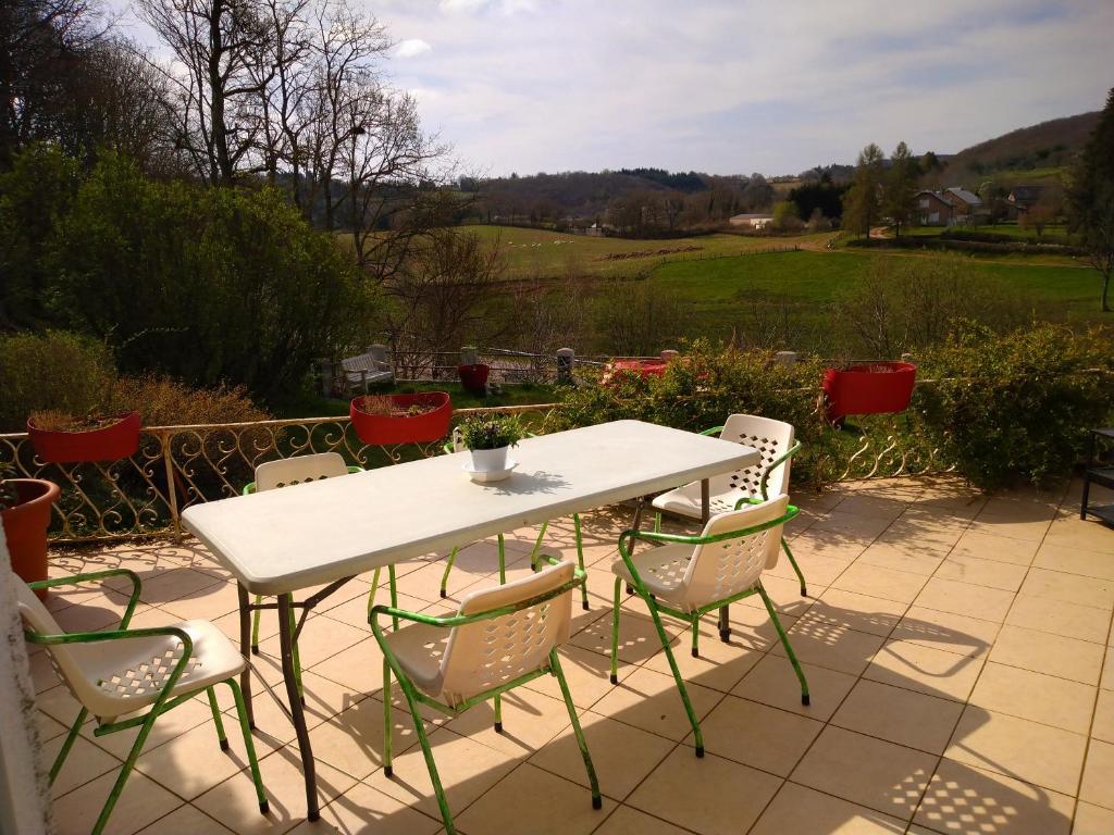 una mesa blanca y sillas en un patio en Maison Haute, en Moux-en-Morvan