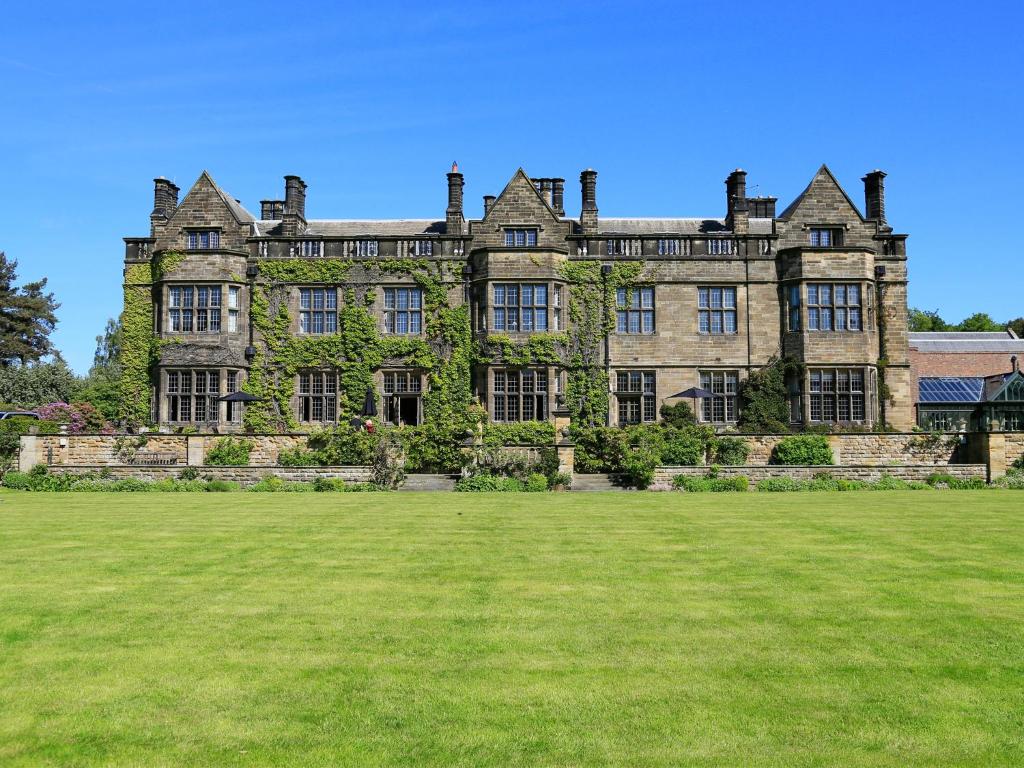 an old castle with a large lawn in front of it at Gisborough Hall Hotel in Guisborough