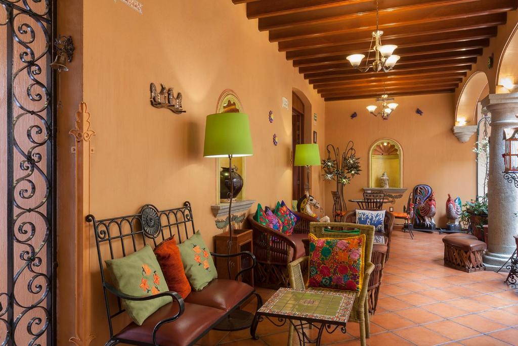 a living room filled with furniture and decor at Hotel Boutique Parador San Miguel Oaxaca in Oaxaca City