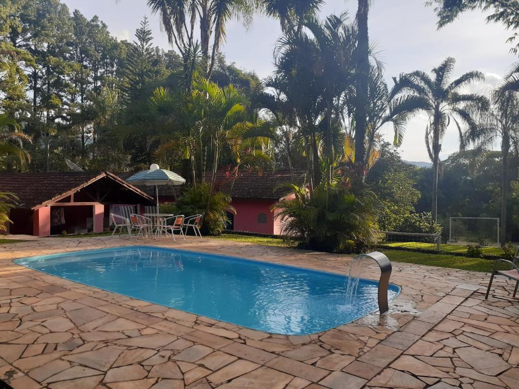 uma piscina com uma fonte de água num quintal em chácara vovó Lucia em Barreira