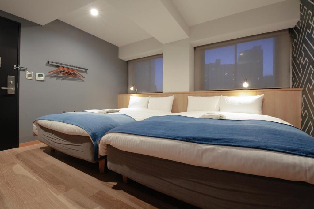 Postel nebo postele na pokoji v ubytování Asakusa Kokono Club Hotel