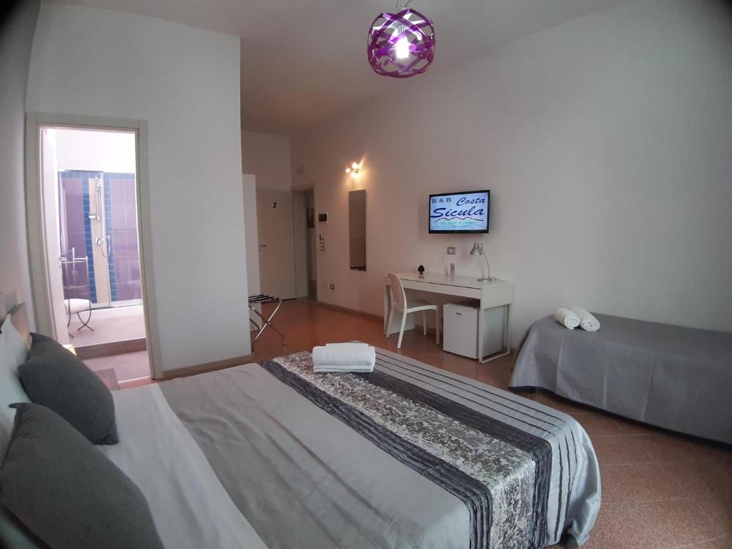 Postel nebo postele na pokoji v ubytování B&B Costa Sicula