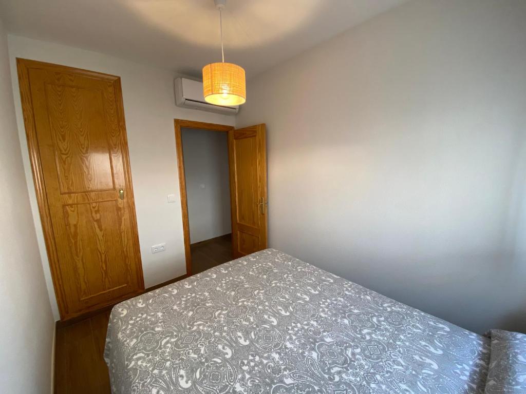 A bed or beds in a room at Arenales Sol y Playa Galatea I