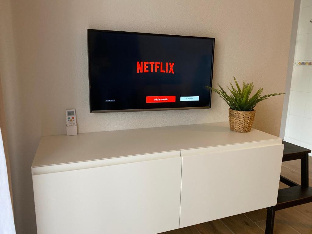 A television and/or entertainment centre at Arenales Sol y Playa Galatea I