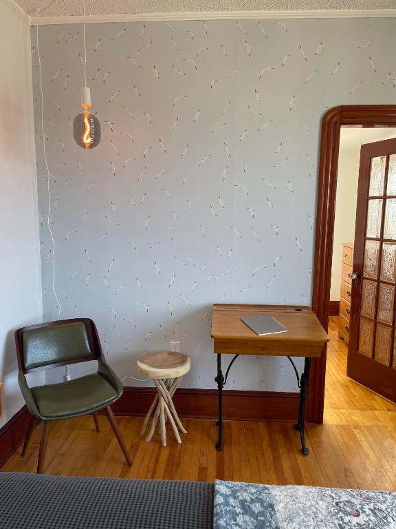 a room with a table and a chair and a desk at The Archie & Isidore Hotel in Chéticamp