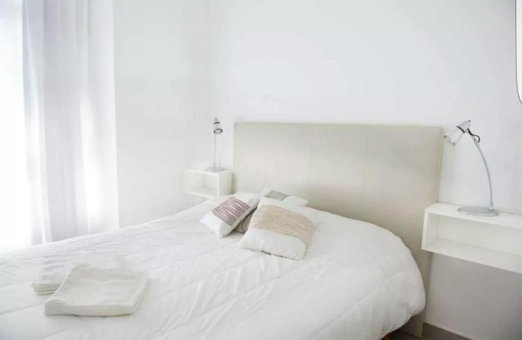 Postel nebo postele na pokoji v ubytování Departamentos Punta Pampa