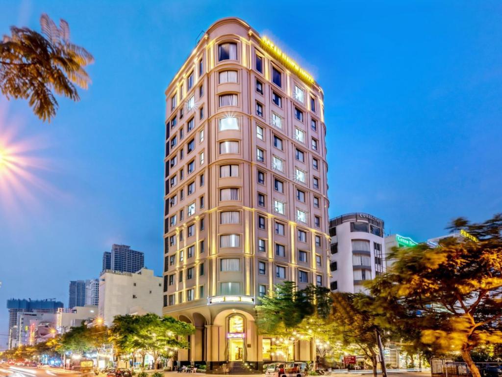 a tall building in a city at night at Ocean Haven Hotel in Danang