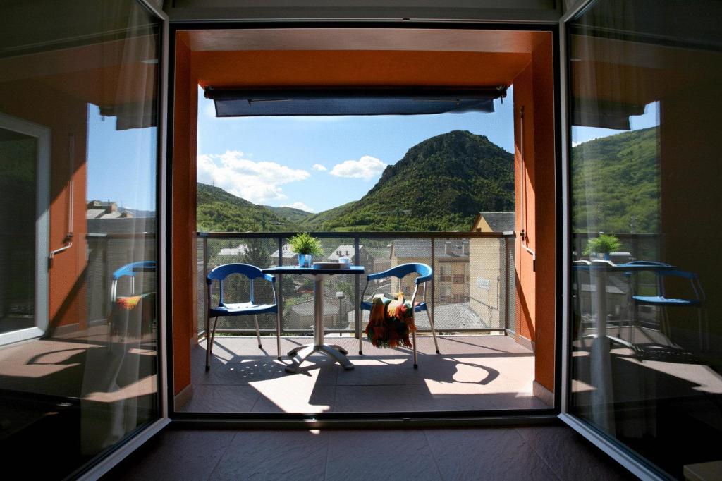 a view of a balcony with a table and chairs at La Faiada in El Pont de Suert