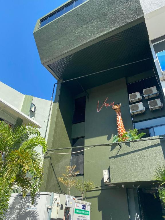 a mural of a giraffe on the side of a building at Very Hotel in George Town
