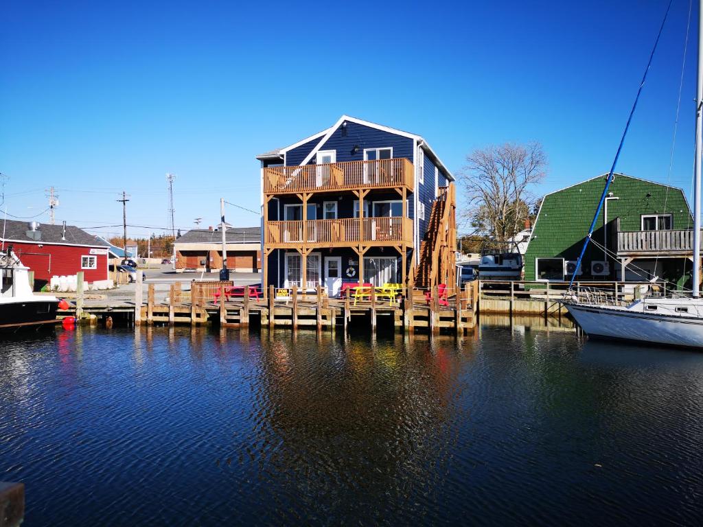 a house on a dock with boats in the water at The Inn at Fisherman's cove in Halifax