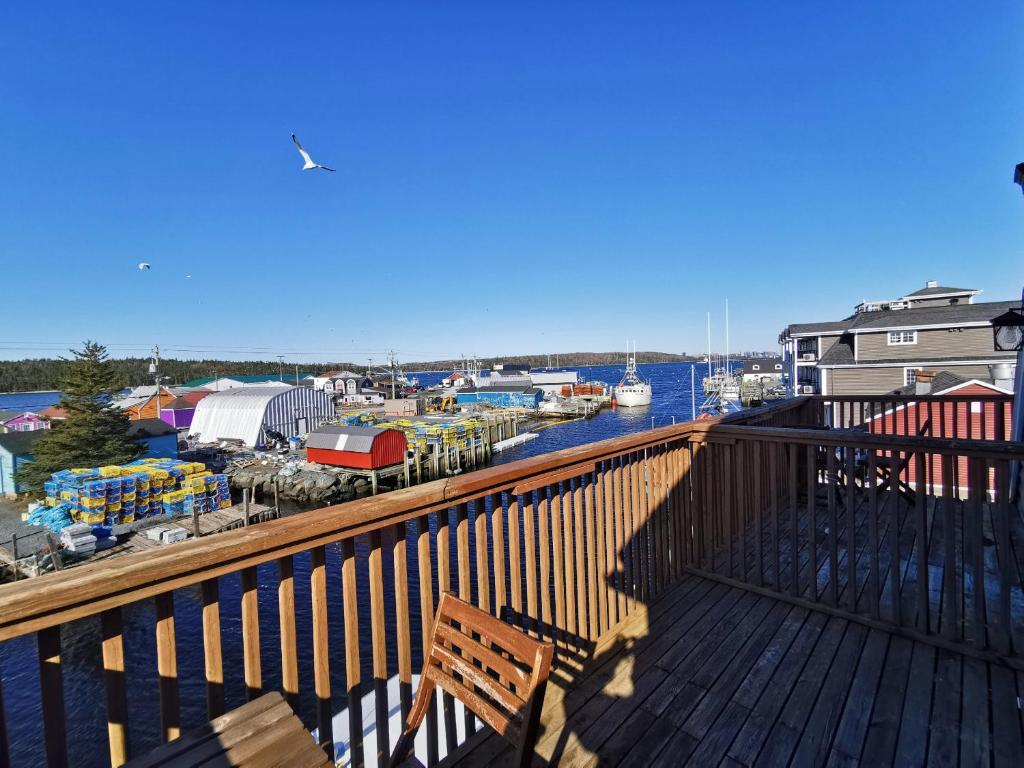 a wooden deck with a bench and a marina at The Inn at Fisherman's cove in Halifax