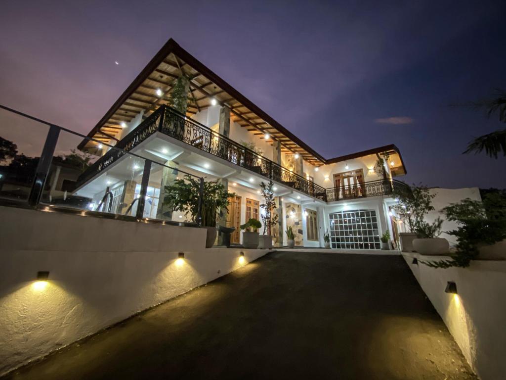 a large house with a balcony at night at Danisco Leisure Bunglow in Kandy