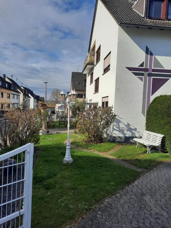 a bench in the grass next to a building with a star on it at Ferienwohnung Hilgert in Sankt Sebastian