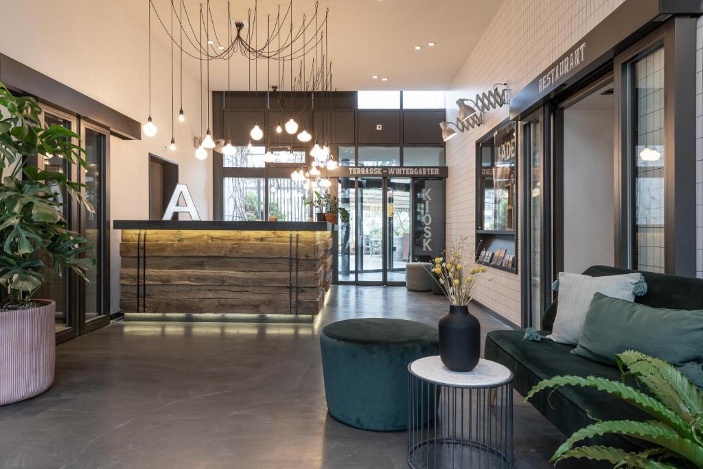 a lobby of a store with a couch and a table at Alpenblick Bern - kind of a hotel in Bern