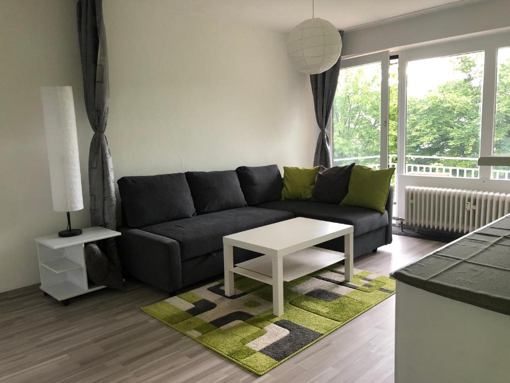 a living room with a couch and a table at Gemütliche Ferienwohnung in Altreichenau in Altreichenau