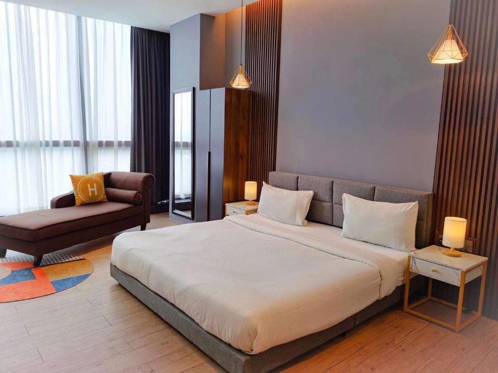 a bedroom with a large bed and a couch at The Parkville - Bangsar Trade Centre in Kuala Lumpur