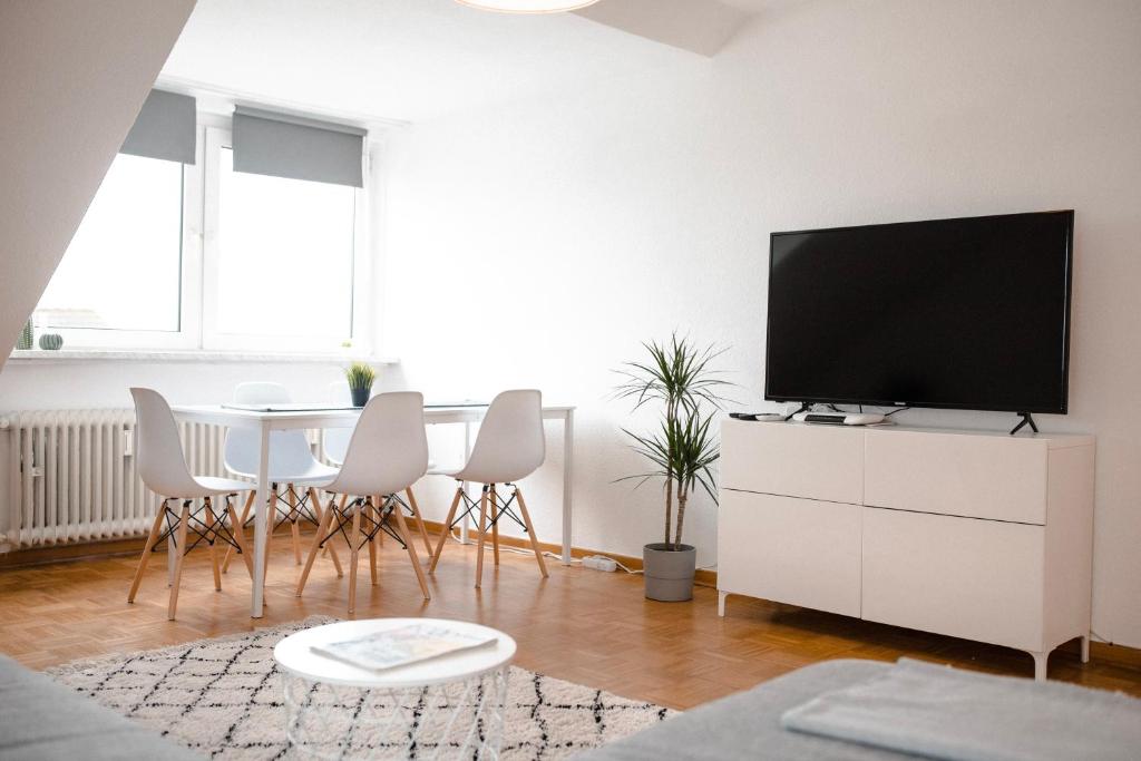 a living room with a tv on a white dresser at - NEU - Sweet Home, Parkplatz, Netflix in Bad Salzuflen