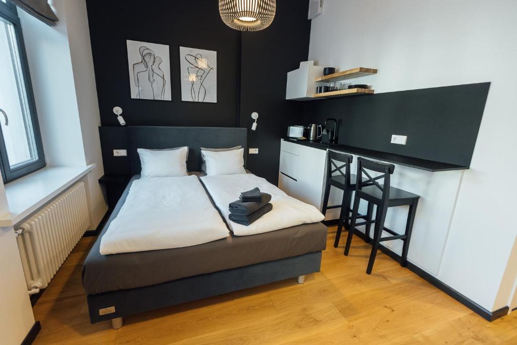 a small bedroom with a bed and a small kitchen at NEW! Elegant Park Studio with A/C near Old Town in Rīga