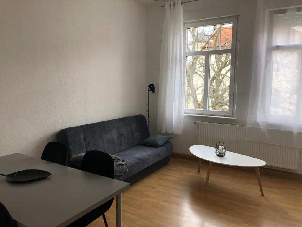 a living room with a couch and a table at Helles Apartment in Quedlinburg