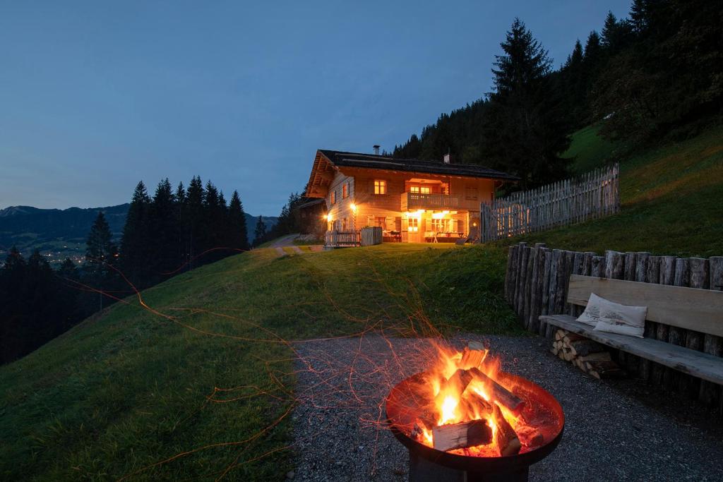 a fire pit in a yard in front of a house at Chalet Berghaus Manuaf in Tschagguns