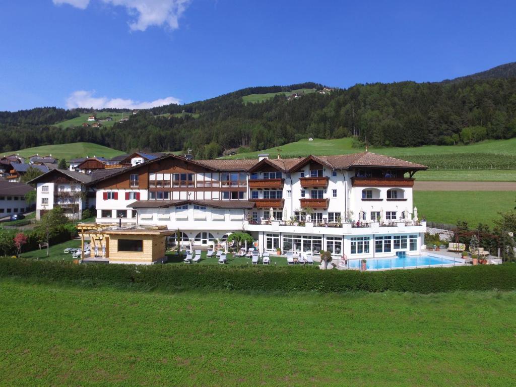 a large building with a pool in the middle of a field at Hotel Schönblick in Rodengo
