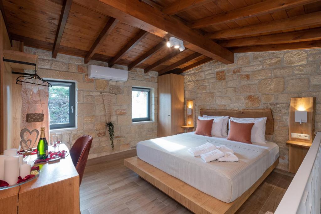 a bedroom with a bed in a stone walled room at Kallithea Village hotel in Kallithea Halkidikis